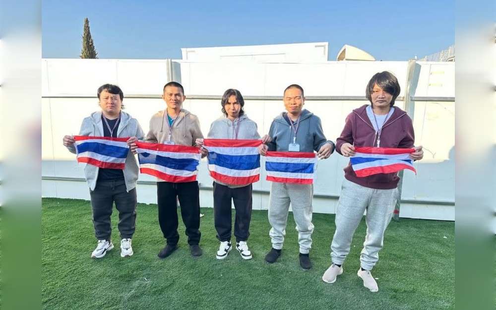 Thai hostages who were freed from Hamas, from left to right: Surasak Lamnao, Sathian Suwannakham, Bannawat Saethao, Watchara Sriaoun, and Pongsak Thaenna hold the Thailand flag in Israel, Jan. 30, 2025.Credit:Royal Thai Embassy in Tel Aviv/Facebook