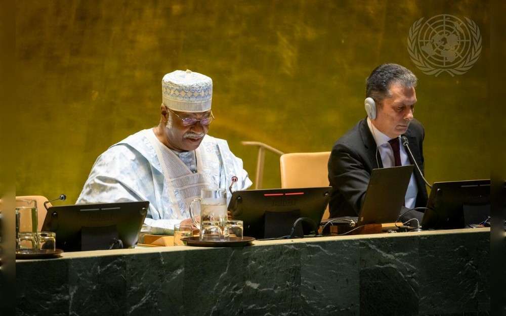 Philemon Yang President of the seventy-ninth session of the United Nations General Assembly, briefs on his priorities for 2025. On the right is Movses Abelian, UN Under-Secretary-General for General Assembly and Conference Management.