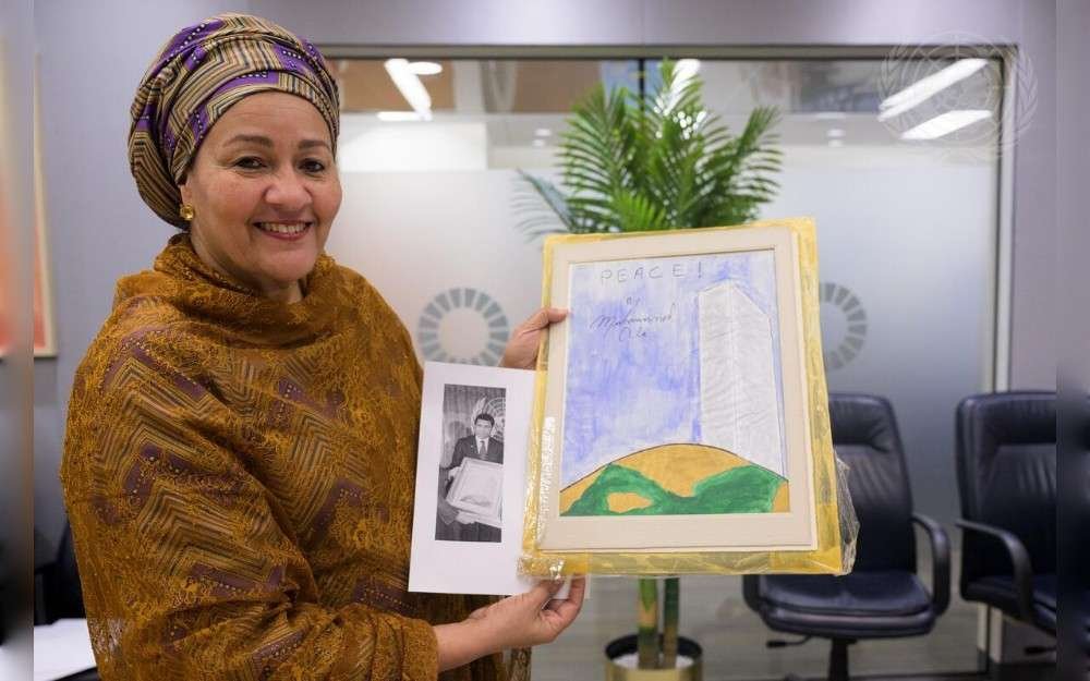 United Nations Deputy Secretary-General Amina Mohammed with an original work of art entitled “Peace”, painted by the boxer and UN Messenger of Peace Muhammad Ali.