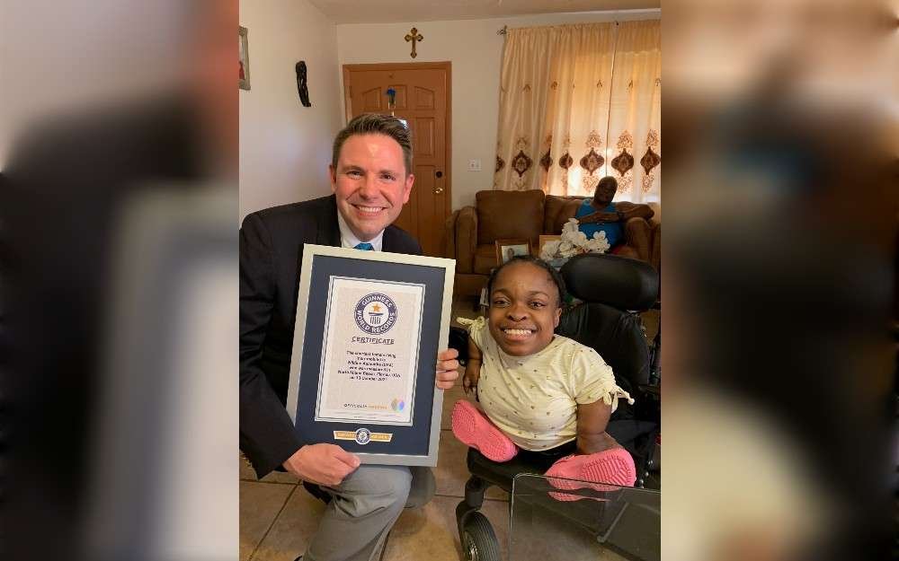 At 72 cm (2 ft 4 in), American Wildine Aumoithe holds a Guinness World Record as the world's smallest professional model and non-mobile woman (2023). She’s graduating from Liberty University in Virginia with a bachelor’s degree in graphic design.