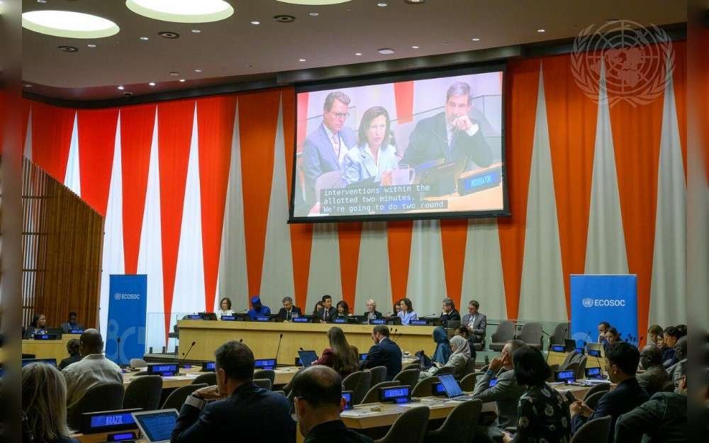 A wide view of the high-level segment of the Economic and Social Council. On the screen is Melissa Fleming, United Nations Under-Secretary-General for Global Communications.